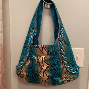 Michael Kors tote snake leather outside & suede inside.